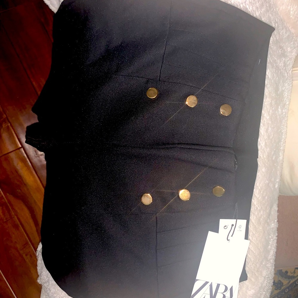 Black leggings with gold buttons